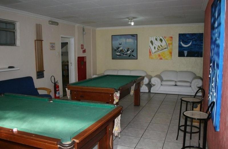 a living room with a pool table in a room at Hotel Capriccio São Caetano in São Caetano do Sul