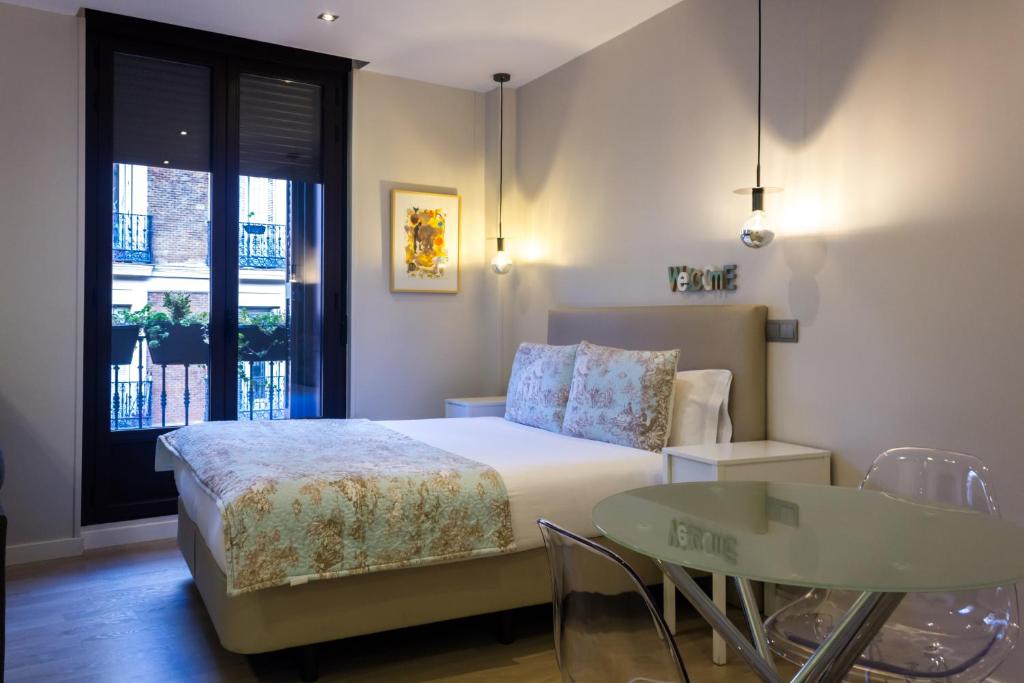 A bed or beds in a room at Arenal Suites Preciados