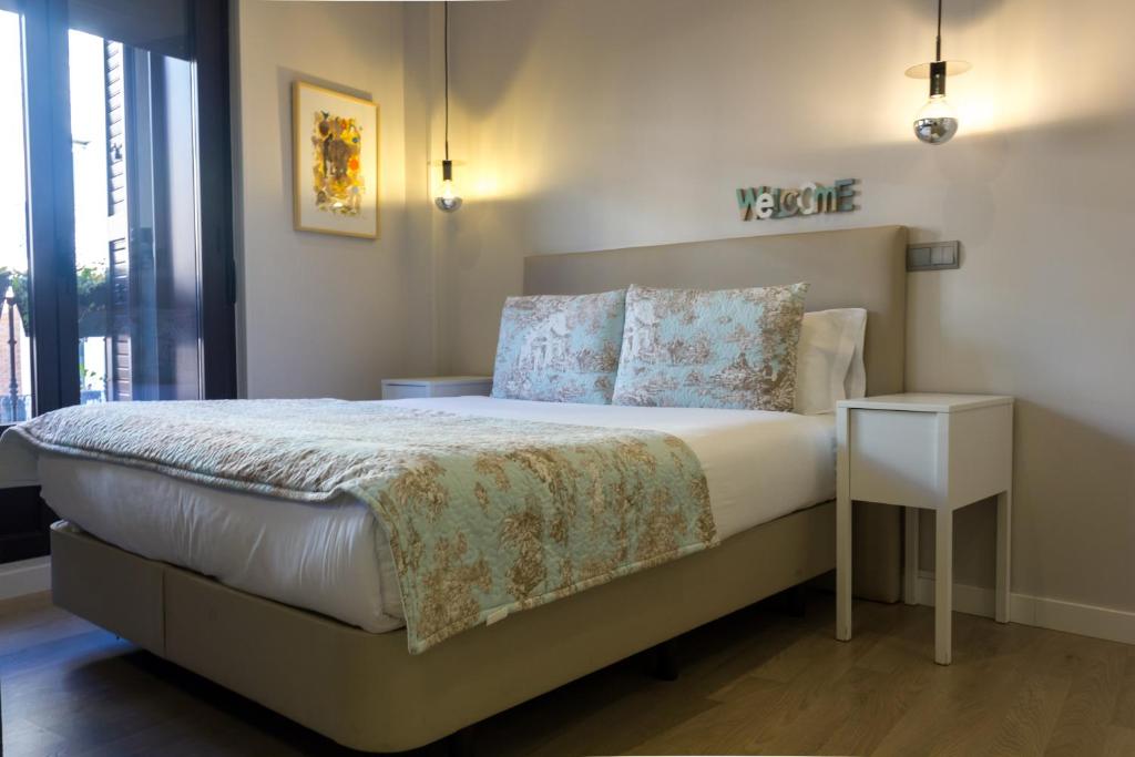 A bed or beds in a room at Arenal Suites Preciados
