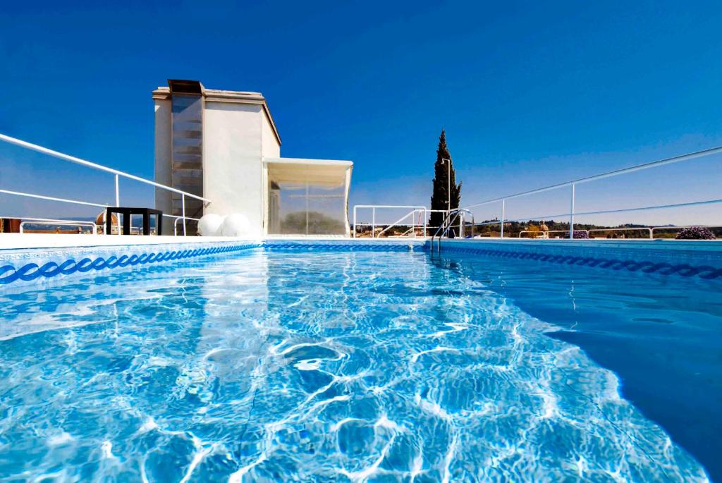 a swimming pool with blue water in front of a building at Hotel Kraft in Florence