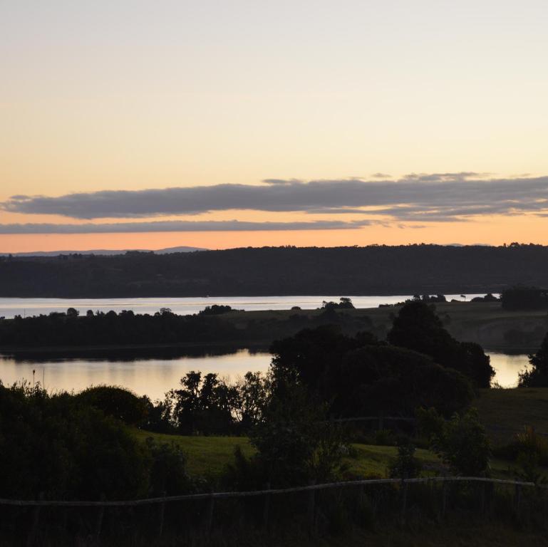a view of a body of water at sunset at domoschiloe in Ancud