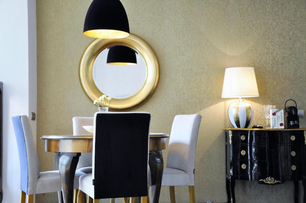 comedor con mesa y espejo en MONDRIAN Luxury Suites & Apartments Krakow Old Town, en Cracovia