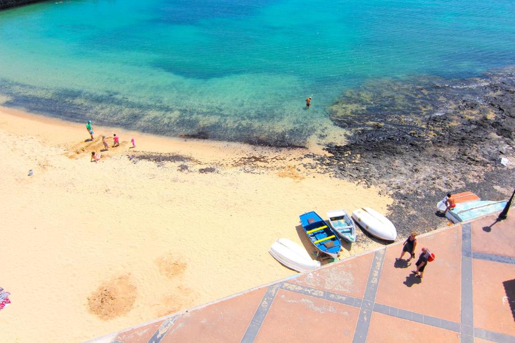 an aerial view of a beach with boats on it at AVANTI Lifestyle Hotel - Only Adults in Corralejo