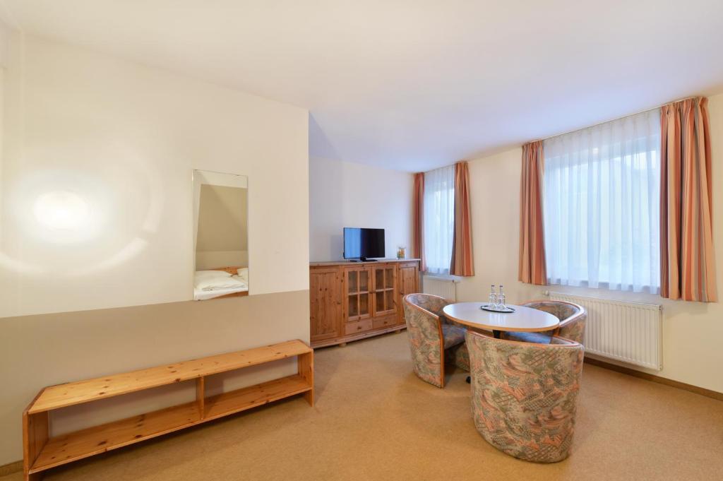 a room with a table and chairs and a bed at meinHotel in Hamburg
