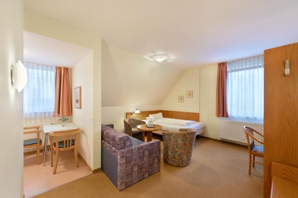a living room with a couch and a table at meinHotel in Hamburg