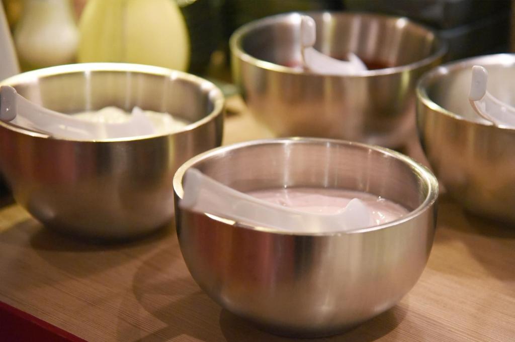 a group of metal bowls on a wooden table at meinHotel in Hamburg