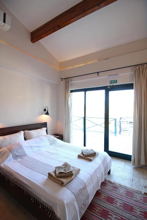 Postel nebo postele na pokoji v ubytování Kekik Otel Selimiye