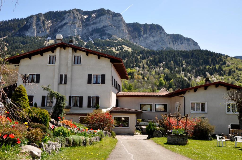 a large house with a mountain in the background at Bon-Séjour in Thollon