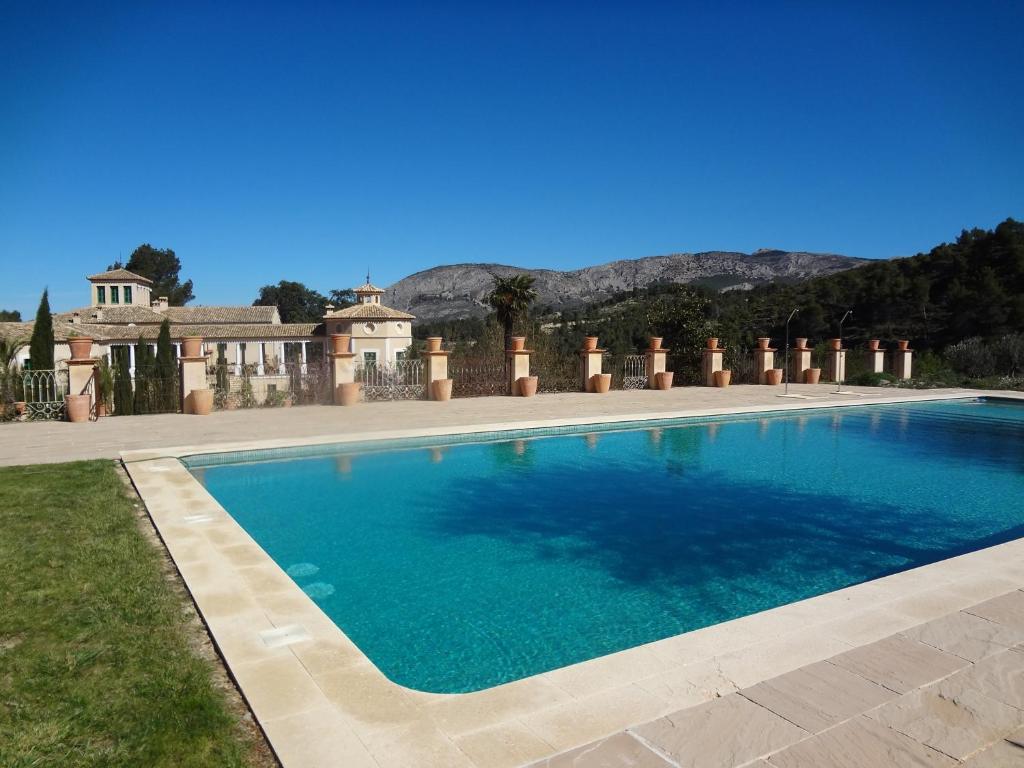 a swimming pool in front of a house at Riola San Gabriel in Alcolecha