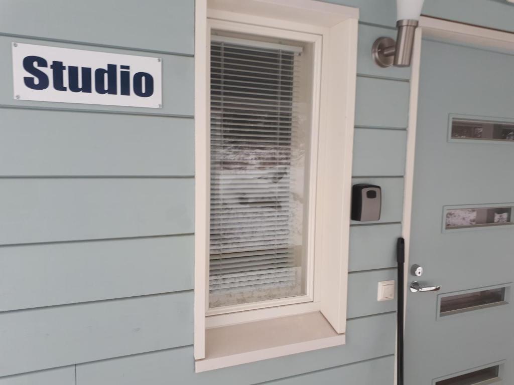 a window on the side of a house with a shutter at Vuokatti Slope Studio in Vuokatti