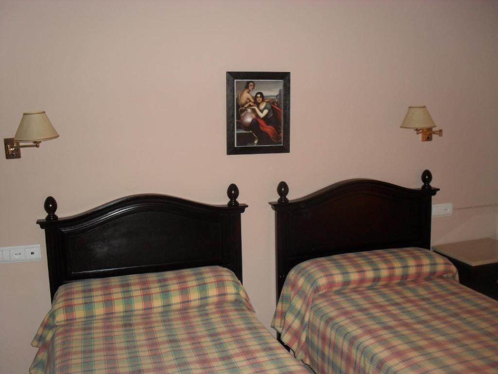 Postel nebo postele na pokoji v ubytování Hostal San Luis