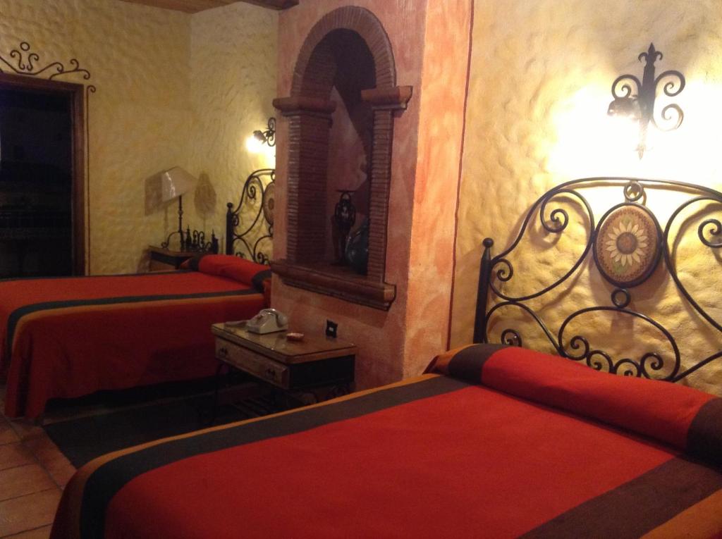 Postel nebo postele na pokoji v ubytování Hotel Los Escudos
