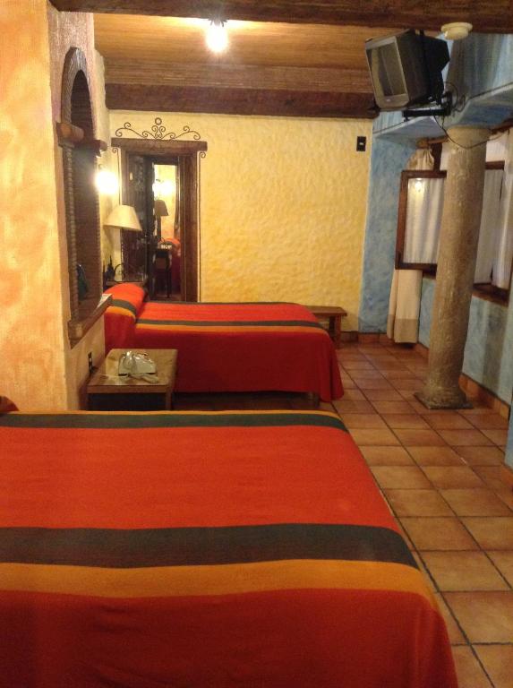 Postel nebo postele na pokoji v ubytování Hotel Los Escudos