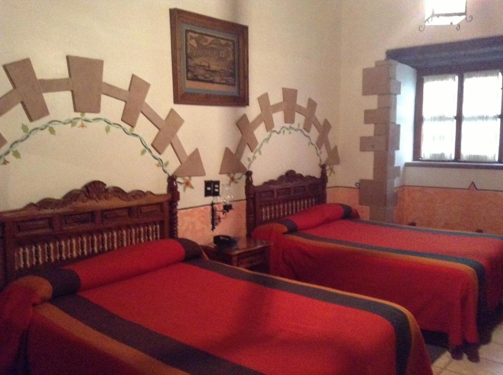 Postel nebo postele na pokoji v ubytování Hotel Los Escudos