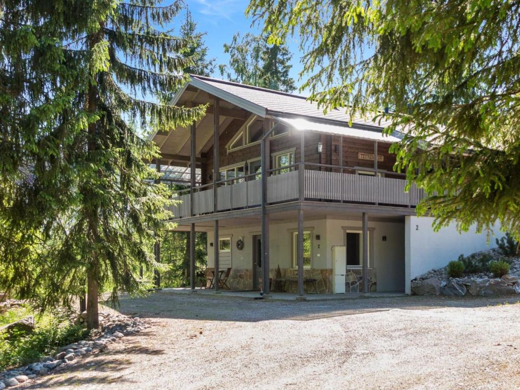 an image of a house with trees in the foreground at Holiday Home Teerenpesä by Interhome in Tahkovuori