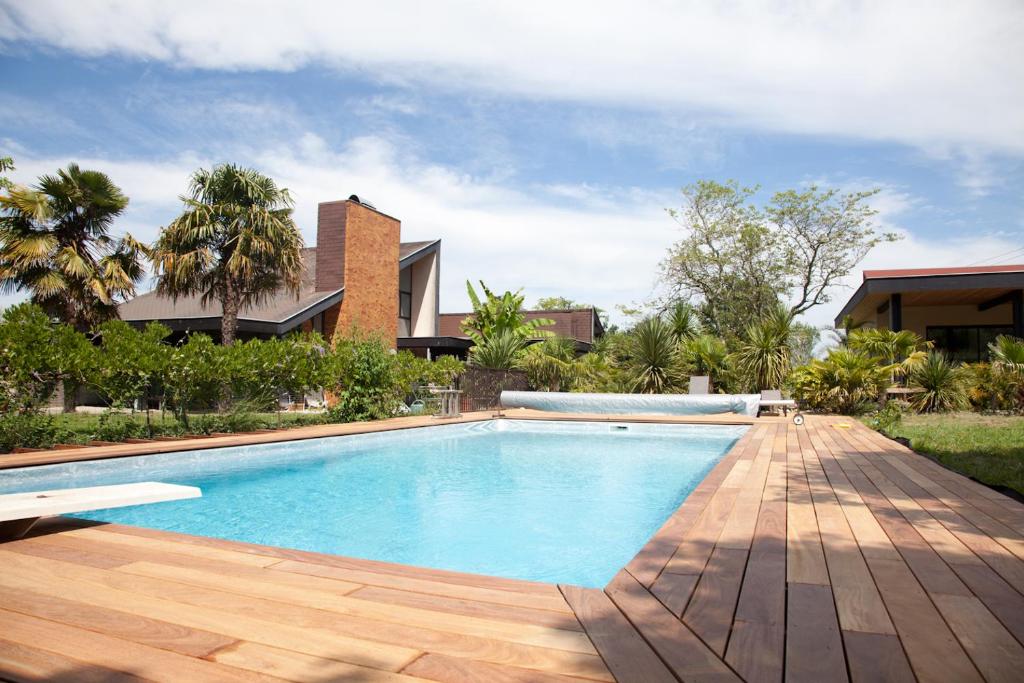 a swimming pool in front of a house at Villa Margaux in Fargues-Saint-Hilaire