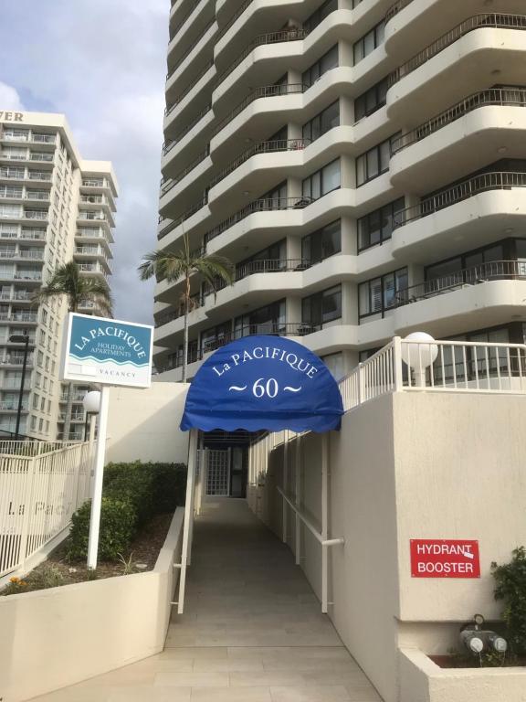 a building with a blue awning in front of it at La Pacifique Apartments in Gold Coast