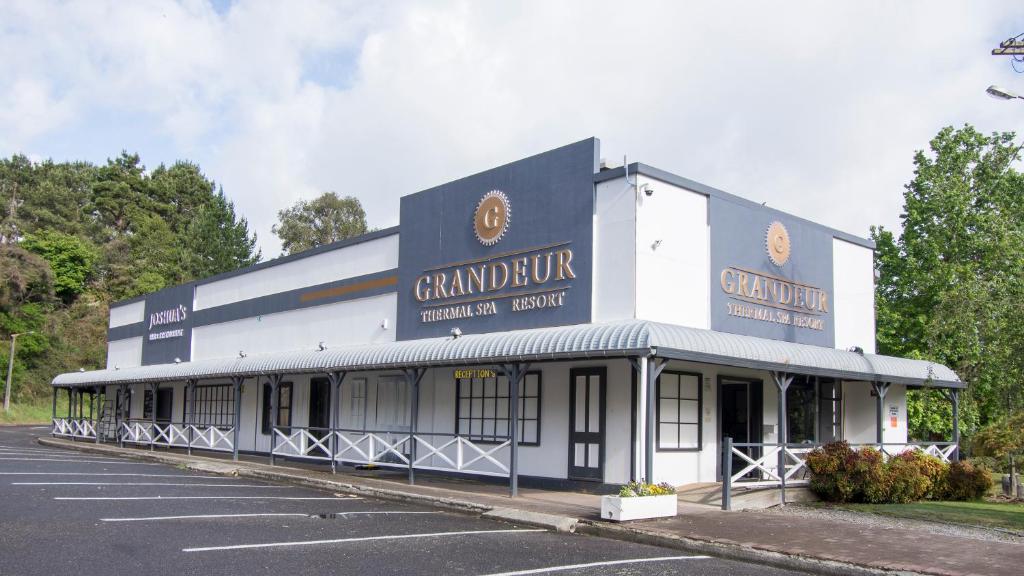 a building with a sign that reads grandbury hospital lecture at Grandeur Thermal Spa Resort in Taupo