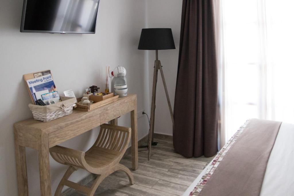 a bedroom with a desk with a chair next to a bed at Hotel Abaco Altea in Altea