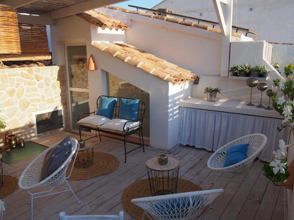 a patio with chairs and tables and a fireplace at Hotel Abaco Altea in Altea