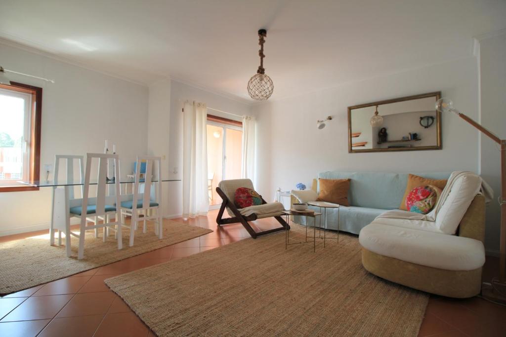 a living room with a couch and a table at Cabedelo Spot - Beachside Vacations in Viana do Castelo