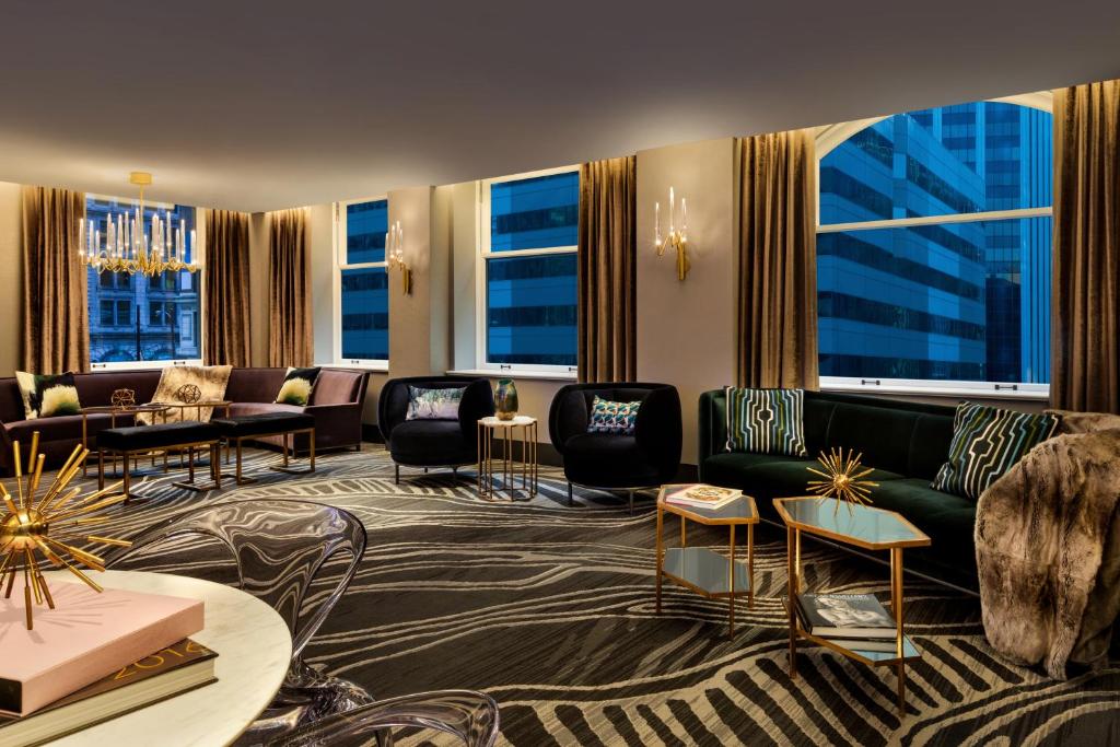a hotel lobby with couches and chairs and windows at EXchange Hotel Vancouver in Vancouver
