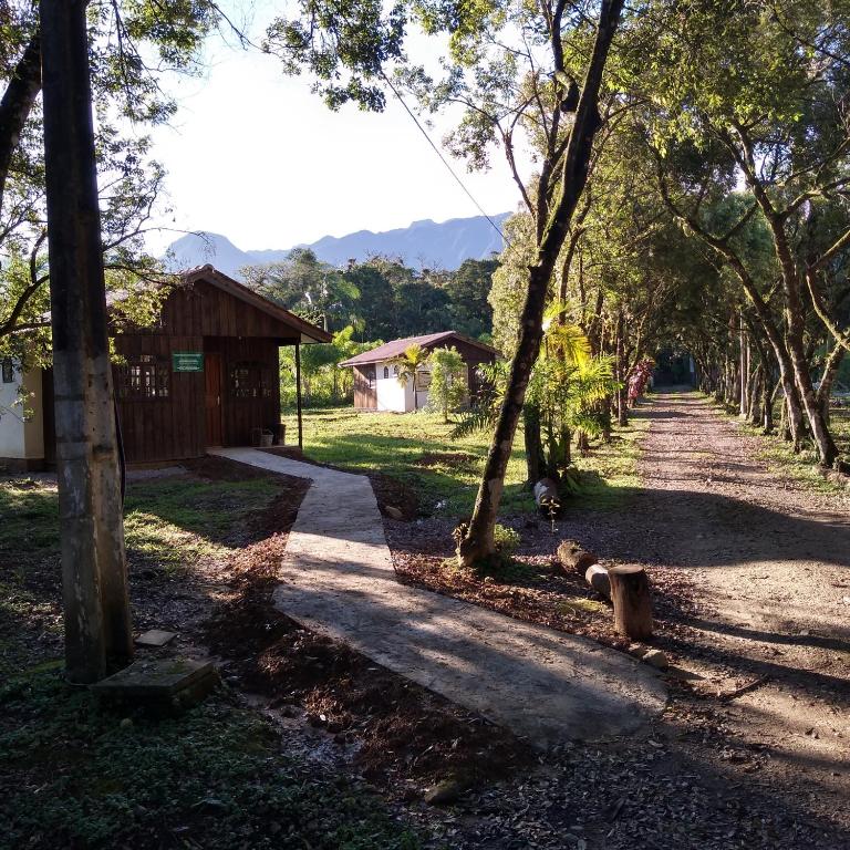 a dirt road with trees and a building at Brisa da Mata Ecolodges in Morretes