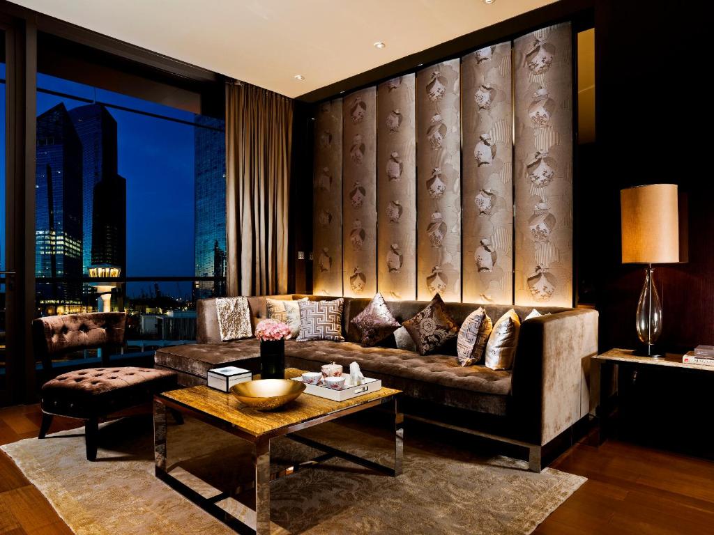 a living room with a couch and a table at The Fullerton Bay Hotel Singapore in Singapore