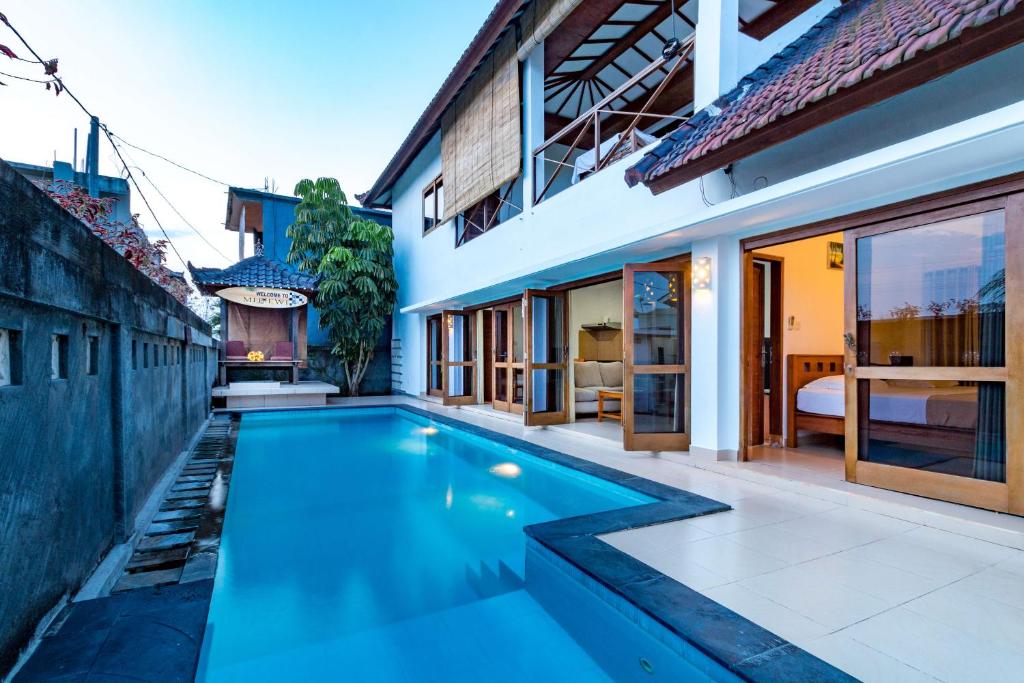 a swimming pool in the backyard of a house at Medewi Surf Villa in Pulukan