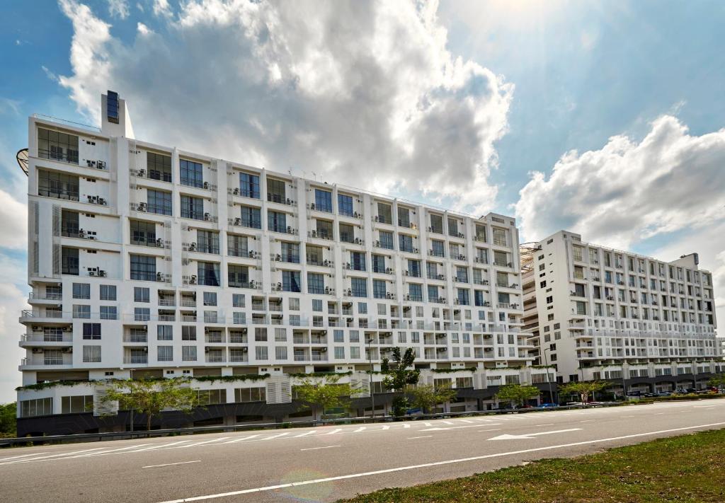 a large white building on the side of a road at Hotel MetraSquare in Melaka