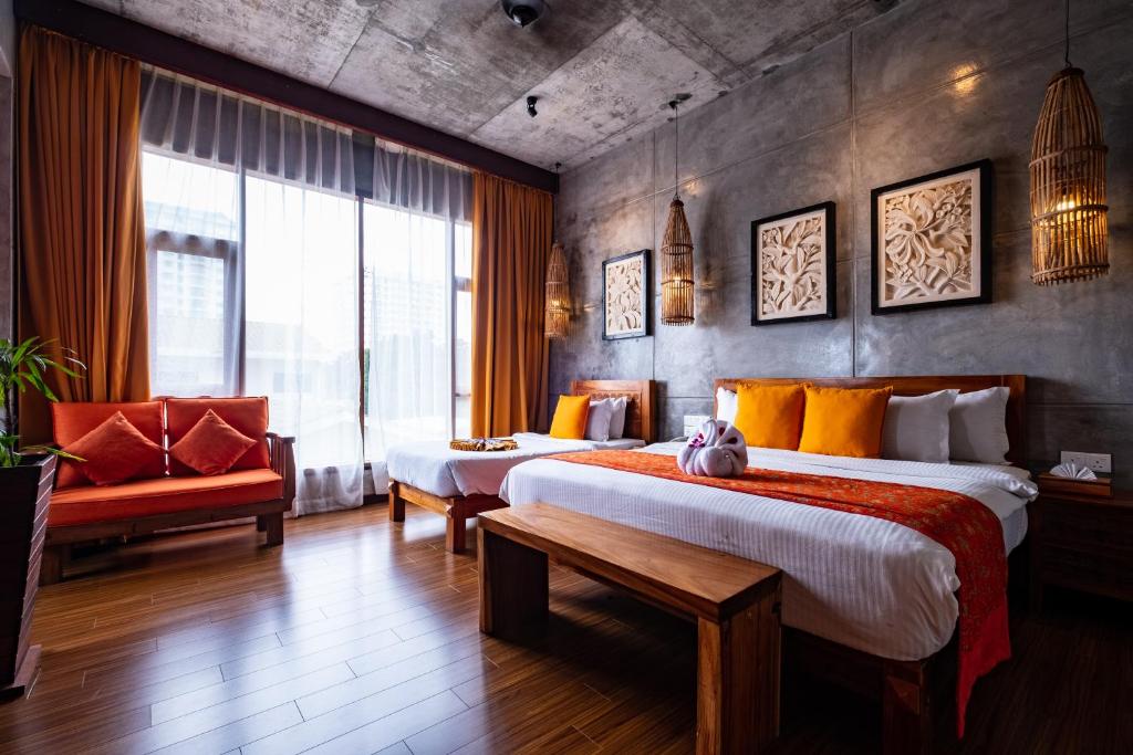 Postel nebo postele na pokoji v ubytování Ipoh Bali Hotel