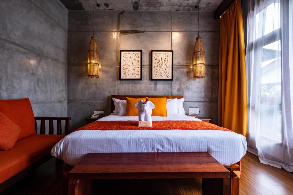 Postel nebo postele na pokoji v ubytování Ipoh Bali Hotel