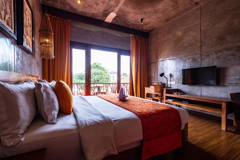 Postel nebo postele na pokoji v ubytování Ipoh Bali Hotel