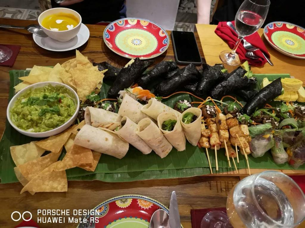a table with a bunch of different types of food at Metteyya Healing House in Ubud