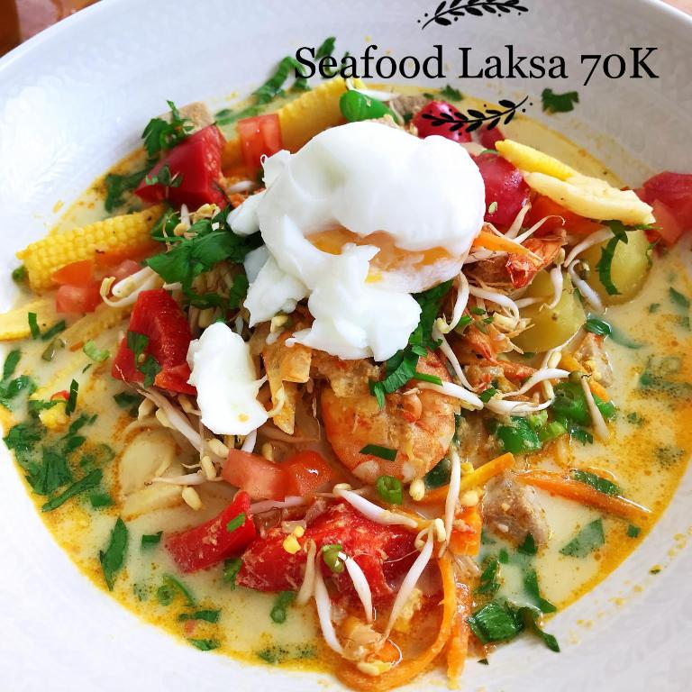 a bowl of seafood lasagna soup with sour cream at Metteyya Healing House in Ubud