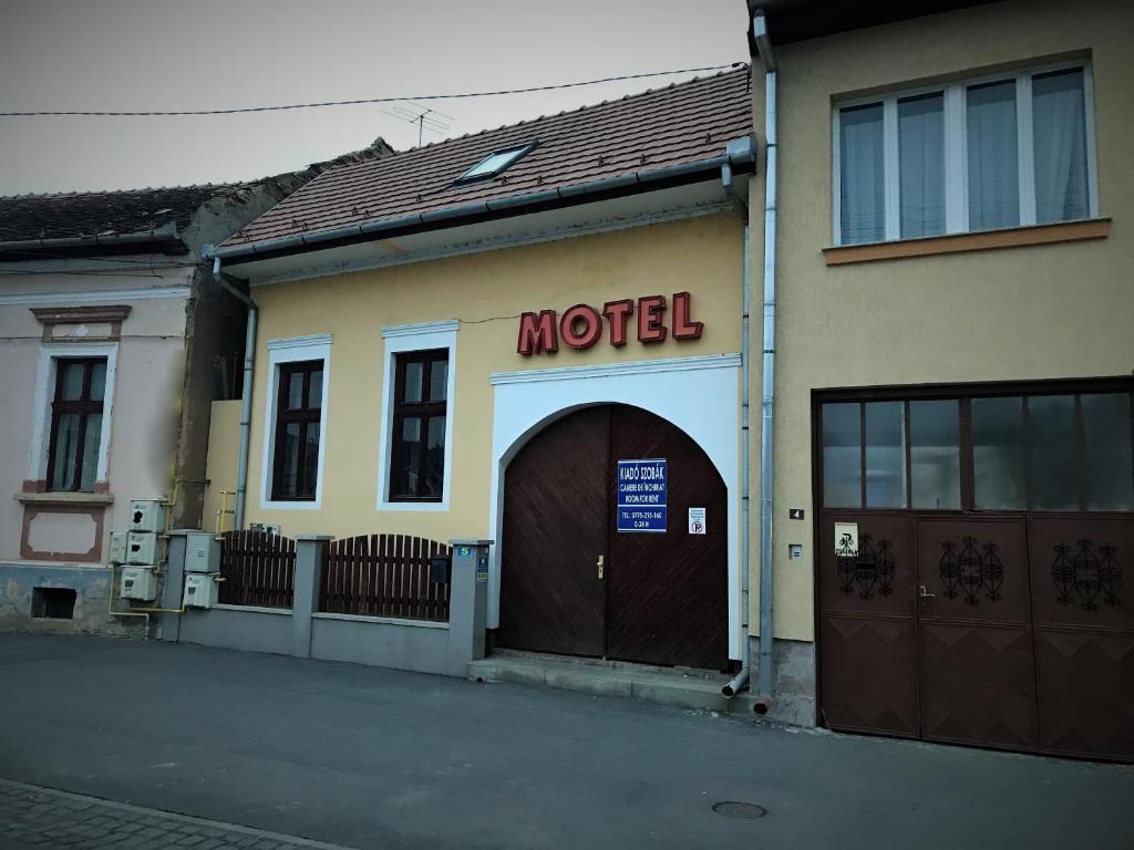 a motel sign on the side of a building at Petőfi Motel in Cristuru Secuiesc