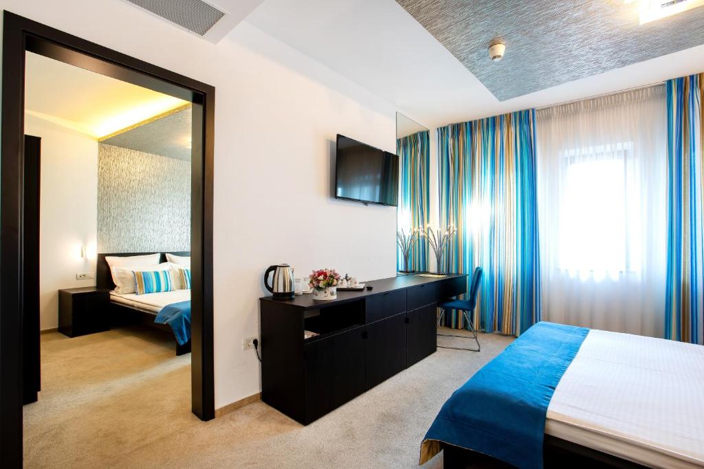 Postel nebo postele na pokoji v ubytování Hotel Duke Romana City Center