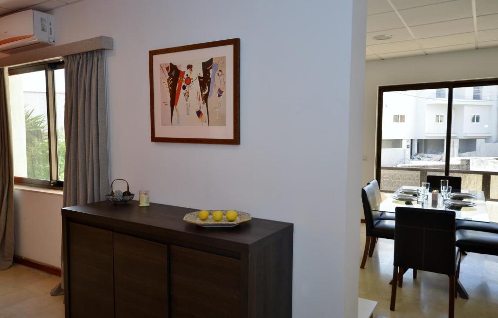 a kitchen and dining room with a table with a bowl of fruit at City Living Suites TK2 Rm 2 in St. Julianʼs