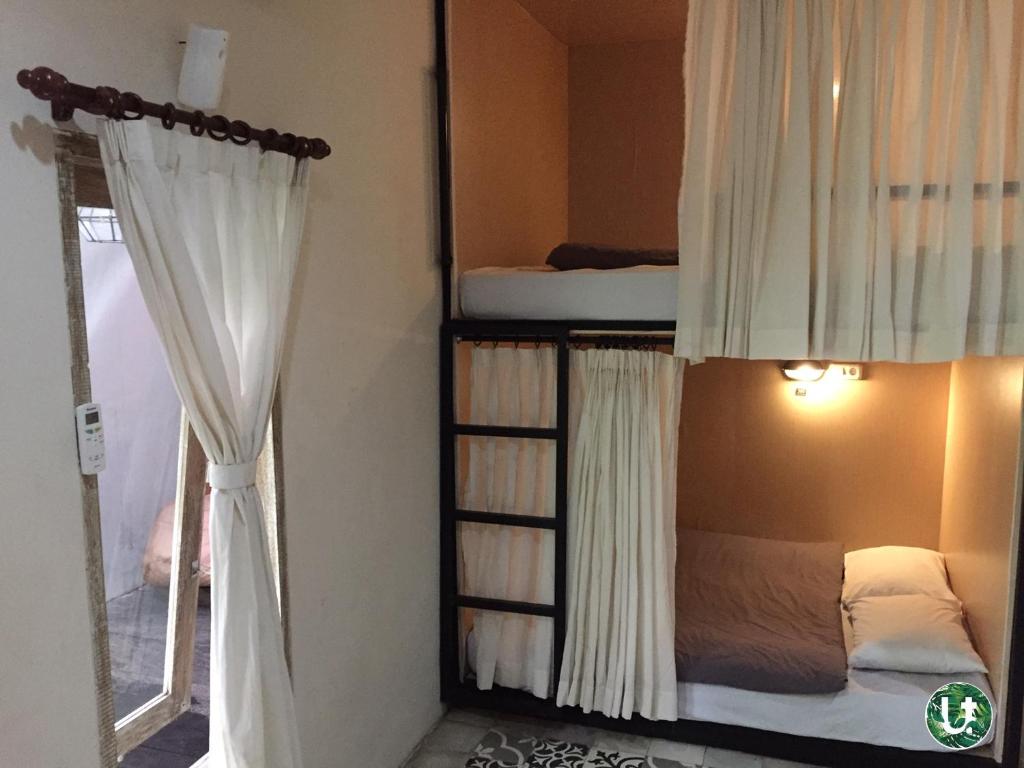 Postel nebo postele na pokoji v ubytování Ubud Tropical
