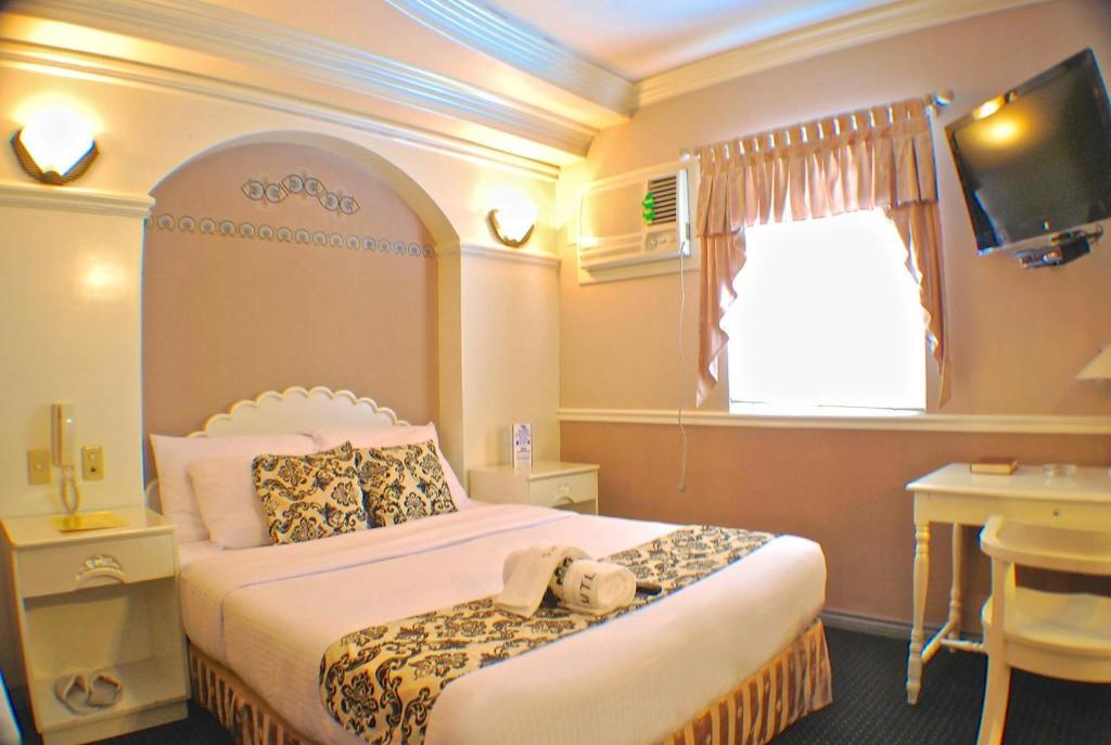 Postel nebo postele na pokoji v ubytování SM Travelodge