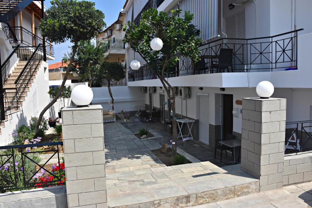a courtyard of a building with a balcony at Vicky Studios in Myrina