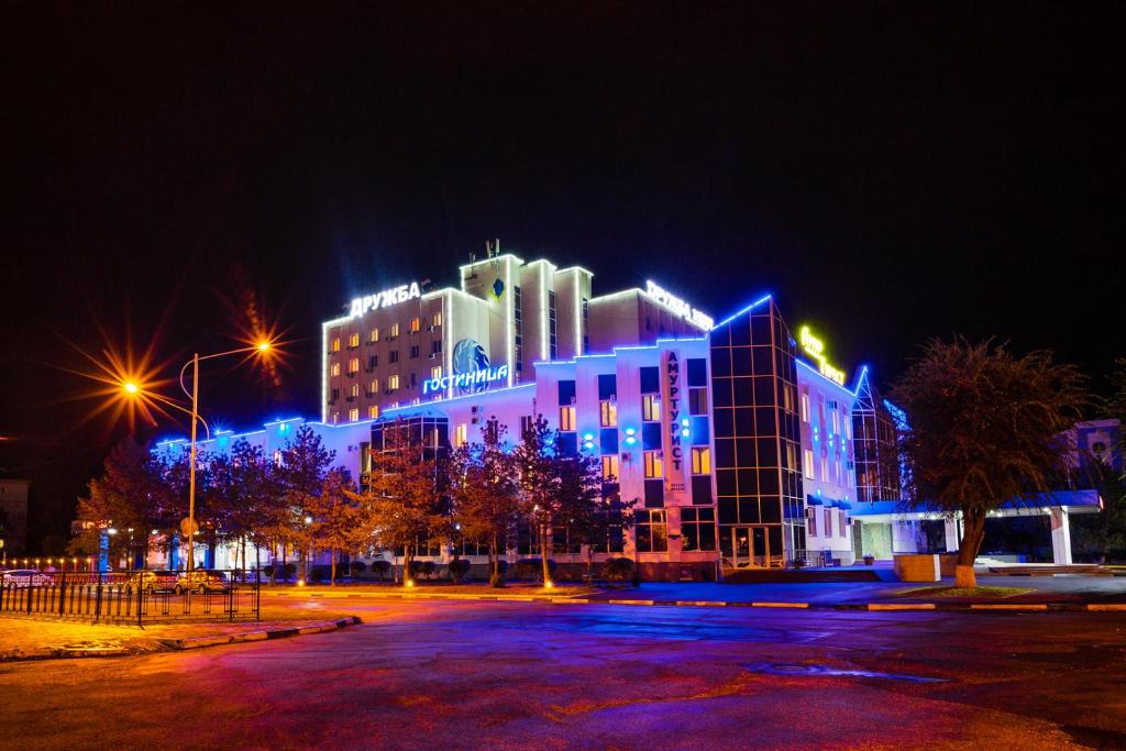 a building with blue lights on it at night at Hotel Druzhba in Blagoveshchensk