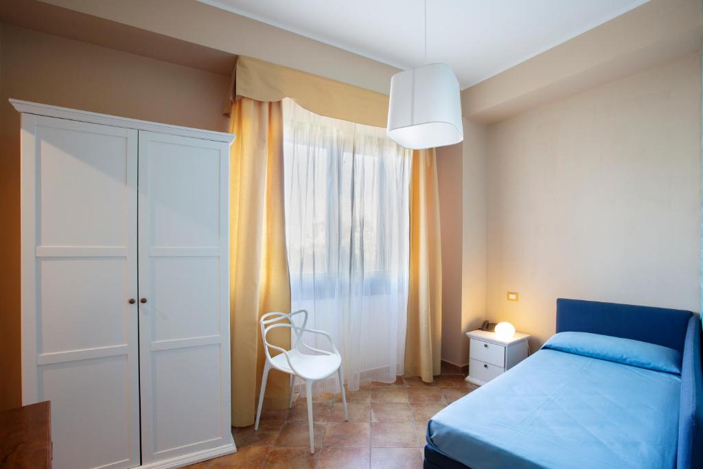Postel nebo postele na pokoji v ubytování FAVIGNANA HOTEL Concept Holiday