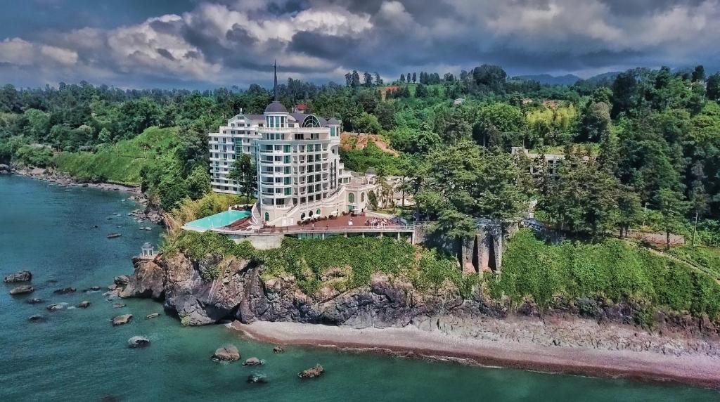 an aerial view of a building on a rocky island in the water at Castello Mare Hotel in K'obulet'i