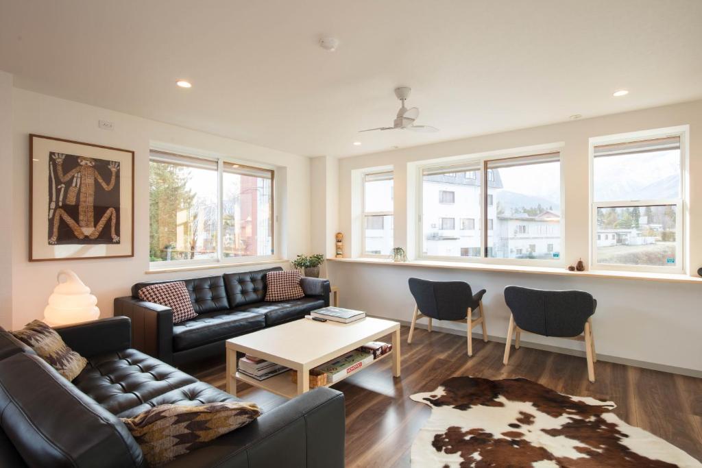 a living room with a couch and a table at Hakuba Downtown Apartments in Hakuba