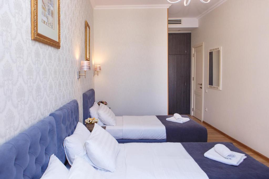 Postel nebo postele na pokoji v ubytování Hotel Arc Tbilisi