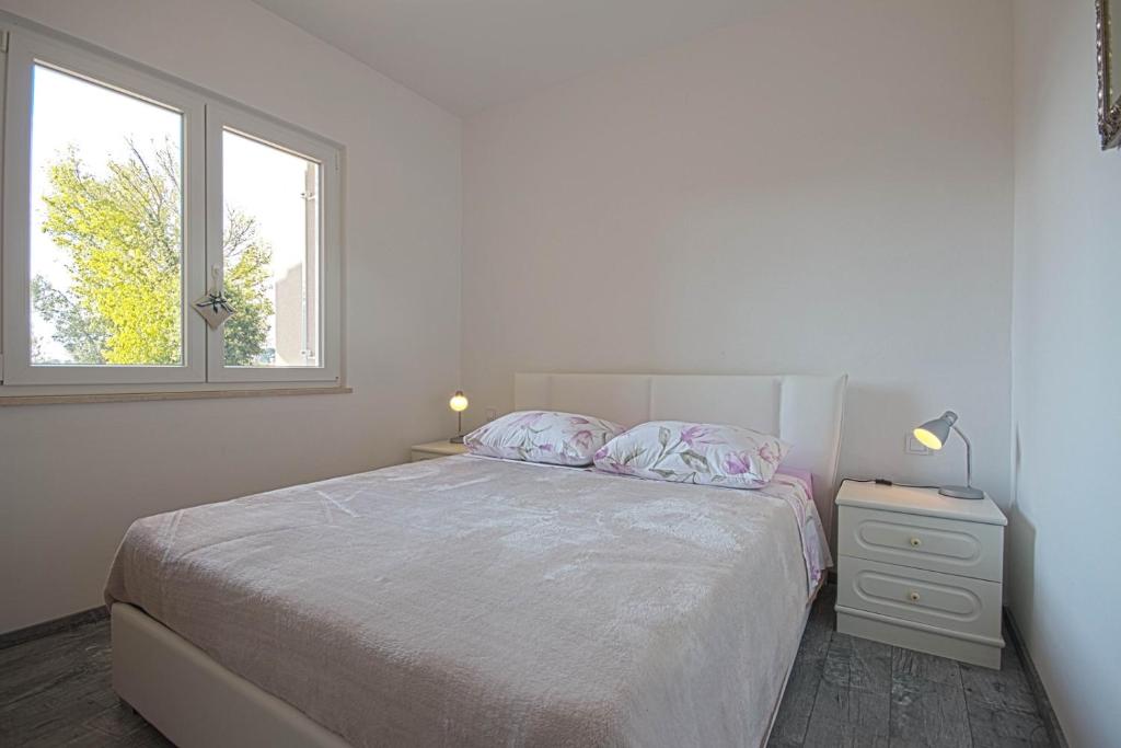 Uma cama ou camas num quarto em Apartman Topolino