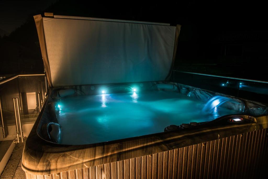 a hot tub sitting on top of a building at night at Ferienwohnung Zillertal Bacher in Schlitters