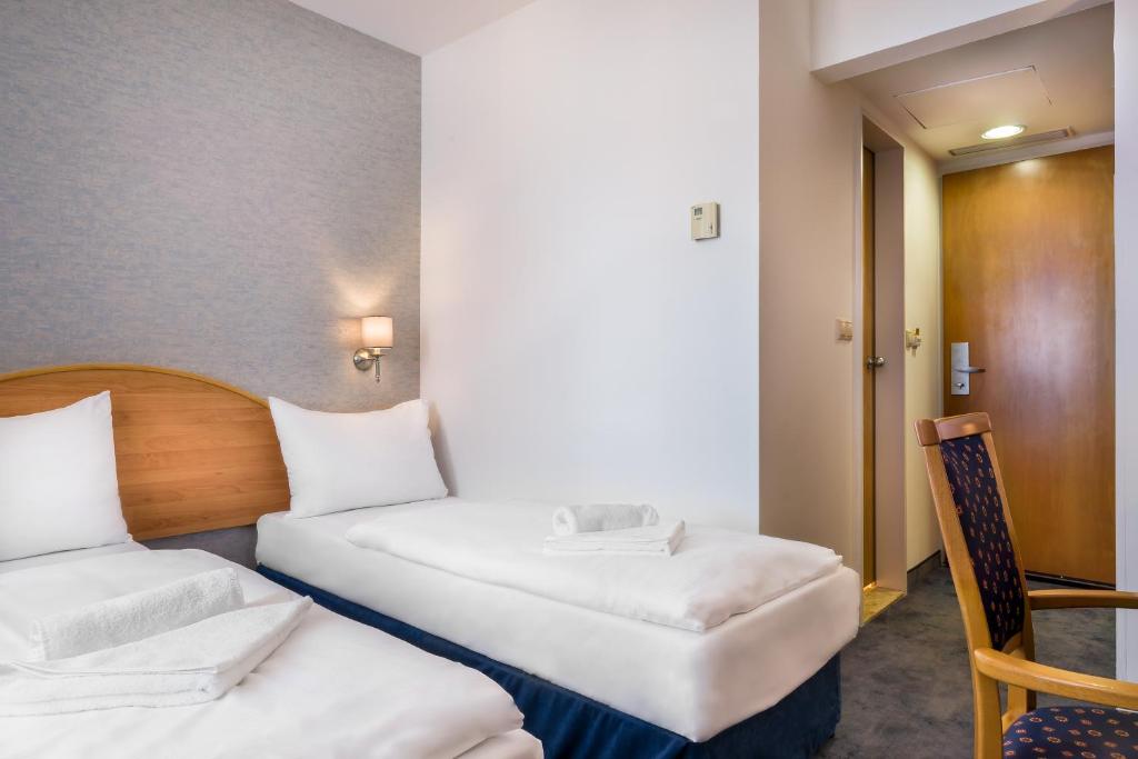 Postel nebo postele na pokoji v ubytování East City Budapest