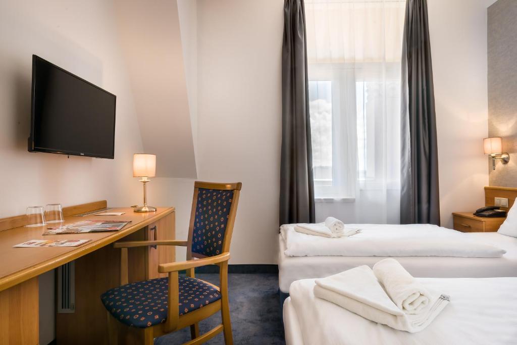 Postel nebo postele na pokoji v ubytování East City Budapest